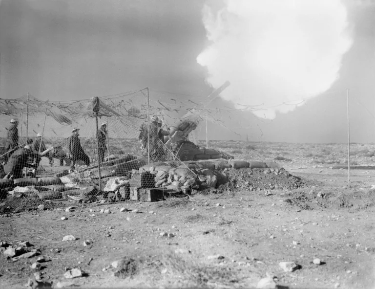 British artillery crew firing a field gun against Italian positions near Derna, Libya, during Operation Compass in February 1941.