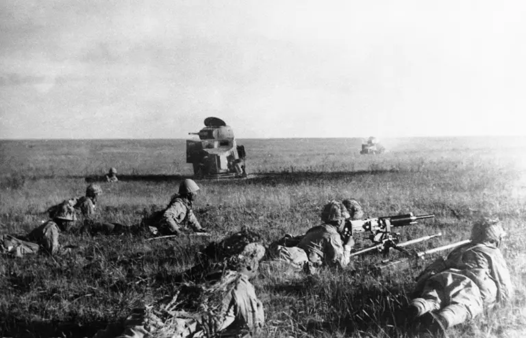 Japanese infantry advancing during the Battle of Khalkhin Gol, 1939, with wrecked Soviet armored vehicles in the background