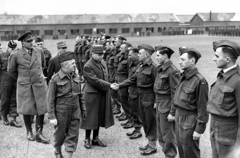 French General Maurice Gamelin shaking hands with British Expeditionary Force soldiers during inspection visit to training camp in Britain, spring 1940