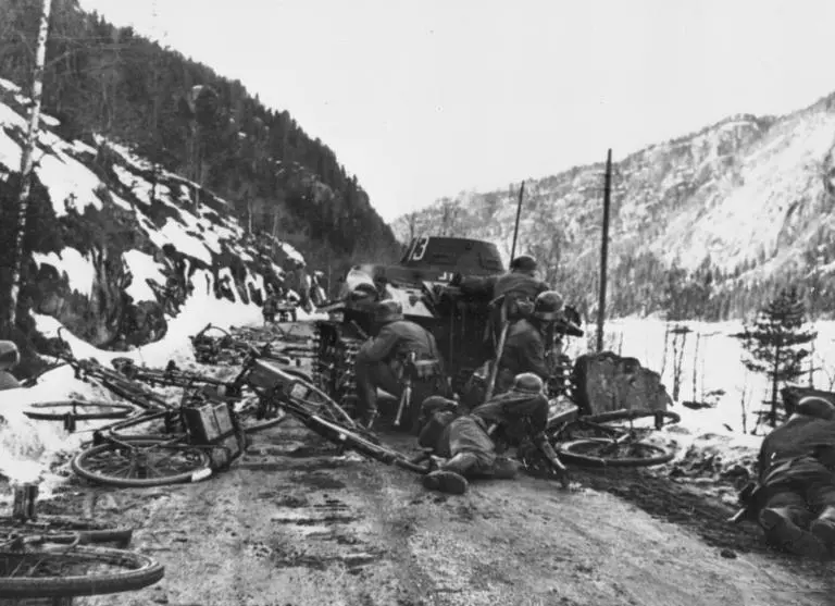 German Wehrmacht infantry and bicycle troops take cover behind a Panzer I light tank on a mountain road during the invasion of Norway, Operation Weserübung, April 1940